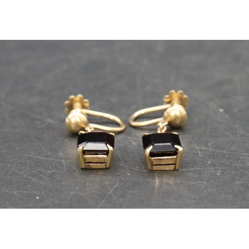 513 - A pair of 18ct gold garnet drop earrings, 5.6 grams gross