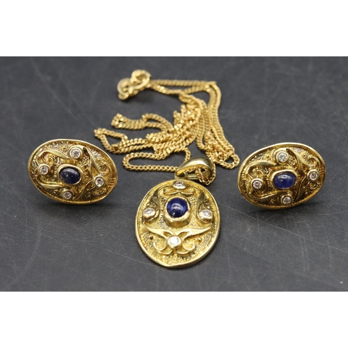 516 - An 18ct gold oval drop pendant with chain and a pair of matching oval earrings, all set with centre ... 