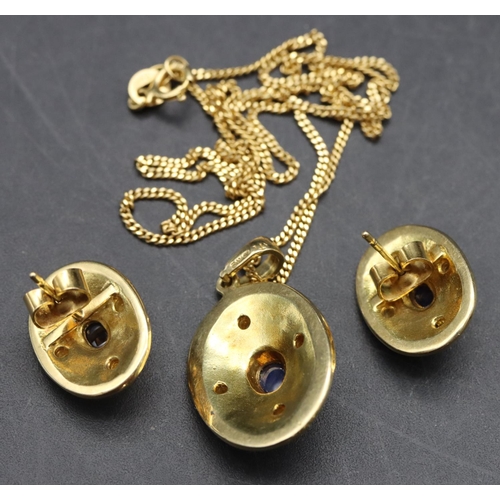 516 - An 18ct gold oval drop pendant with chain and a pair of matching oval earrings, all set with centre ... 