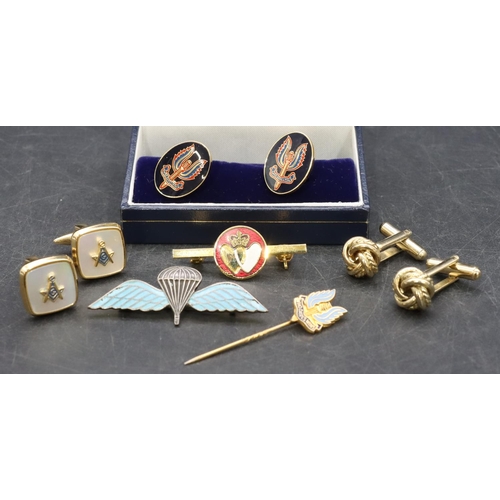 517 - A parachute wings pin badge with tortoiseshell enamel decoration, a pair of military cufflinks, 2 ot... 