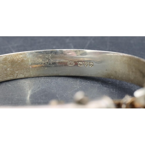 527 - An oval cameo figurehead of a lady, a Chester silver hinged bangle with engraved decoration and a sm... 