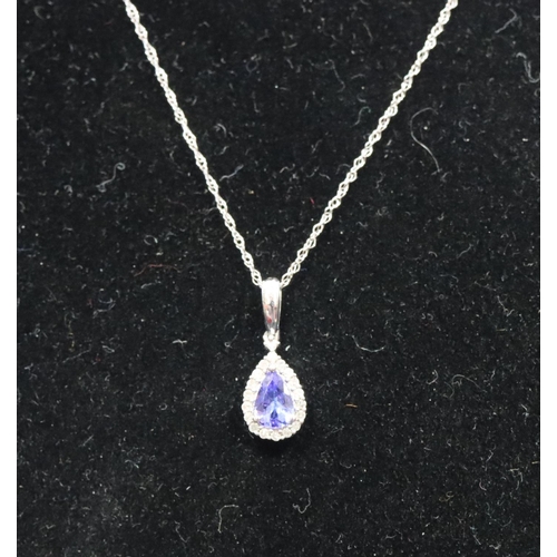 541 - A small 9ct gold pendant with chain set with blue stone surrounded by small diamond chips