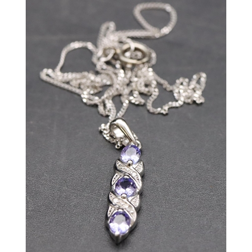 542 - A 9ct white gold small drop pendant set with pale blue stones and small diamond chips with chain, 2.... 