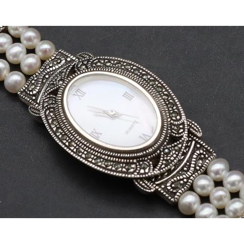 554 - A modern Sterling silver ladies' oval wristwatch with cut steel decoration and pearl style bracelet