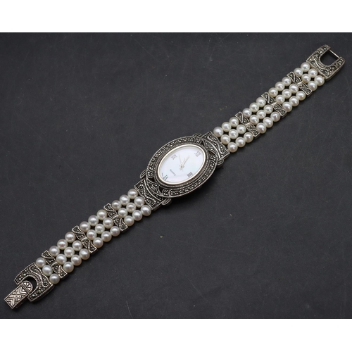 554 - A modern Sterling silver ladies' oval wristwatch with cut steel decoration and pearl style bracelet