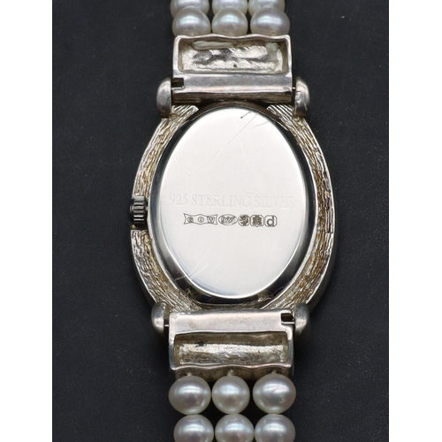 554 - A modern Sterling silver ladies' oval wristwatch with cut steel decoration and pearl style bracelet