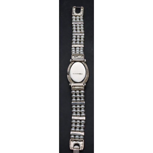 554 - A modern Sterling silver ladies' oval wristwatch with cut steel decoration and pearl style bracelet