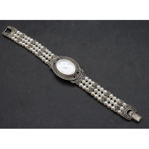 554 - A modern Sterling silver ladies' oval wristwatch with cut steel decoration and pearl style bracelet