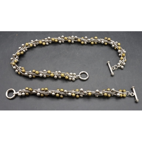 556 - A 925 silver and gilt metal ball necklace with matching bracelet