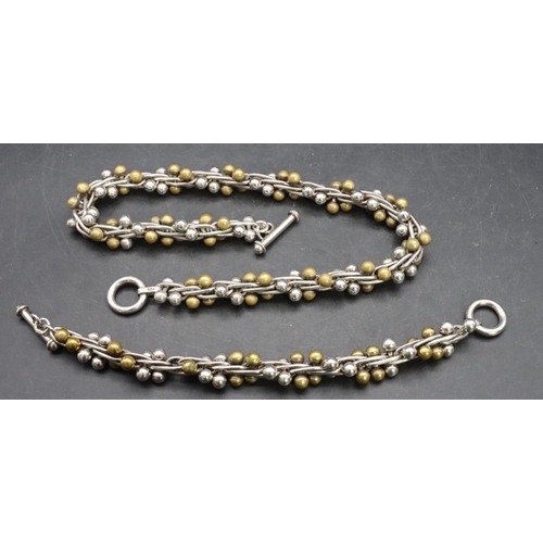 556 - A 925 silver and gilt metal ball necklace with matching bracelet