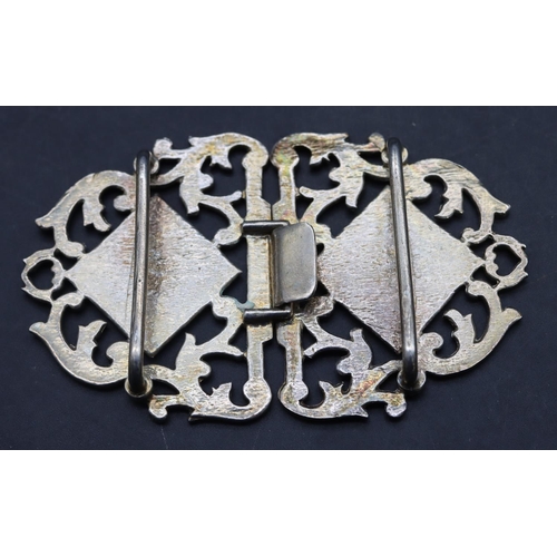 561 - A London silver nurses buckle with pierced scroll and floral decoration, 8.5cm wide, 43.4 grams