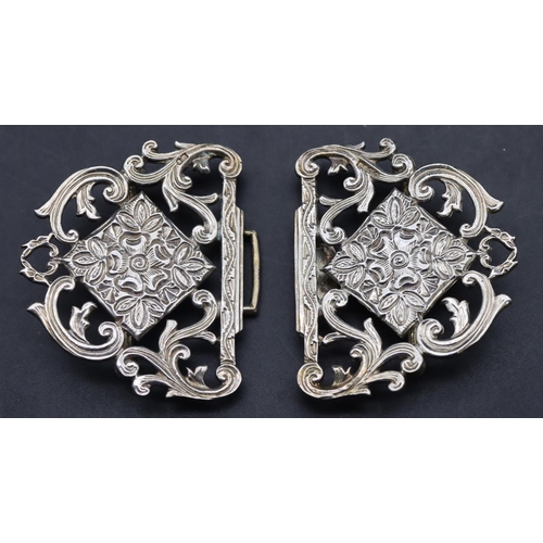 561 - A London silver nurses buckle with pierced scroll and floral decoration, 8.5cm wide, 43.4 grams