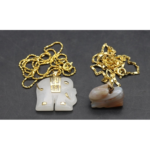 569 - A small white pendant in the form of an elephant with chain and a similar hardstone figure of a rabb... 