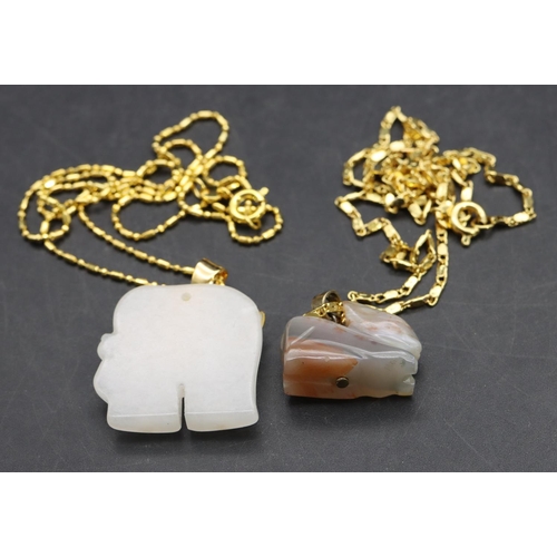 569 - A small white pendant in the form of an elephant with chain and a similar hardstone figure of a rabb... 