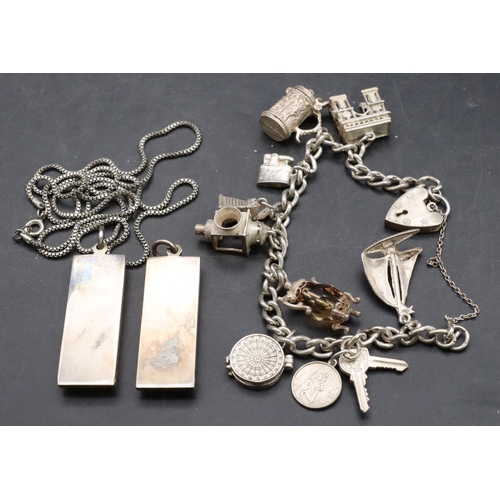 583 - A silver charm bracelet mounted with 8 charms and 2 silver nugget pendants (1 with chain), 108.8 gra... 