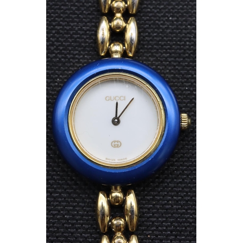 588 - A ladies' Gucci wristwatch with various coloured bezels, with certificate