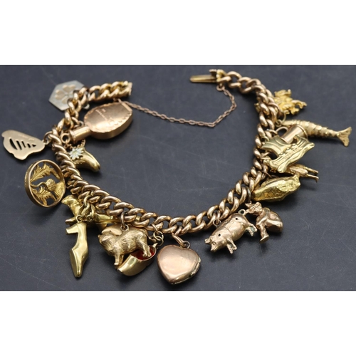 591 - A 15ct gold linked bracelet mounted with 18 charms ( mostly 9ct, 1 x 14ct and 2 x silver), 46.3 gram... 