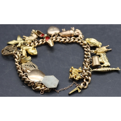 591 - A 15ct gold linked bracelet mounted with 18 charms ( mostly 9ct, 1 x 14ct and 2 x silver), 46.3 gram... 