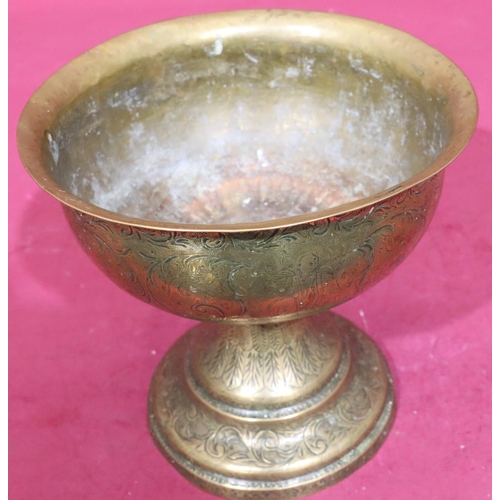 611 - An Indian brass round bulbous trumpet shaped bowl on sweeping foot with engraved figure and scroll d... 