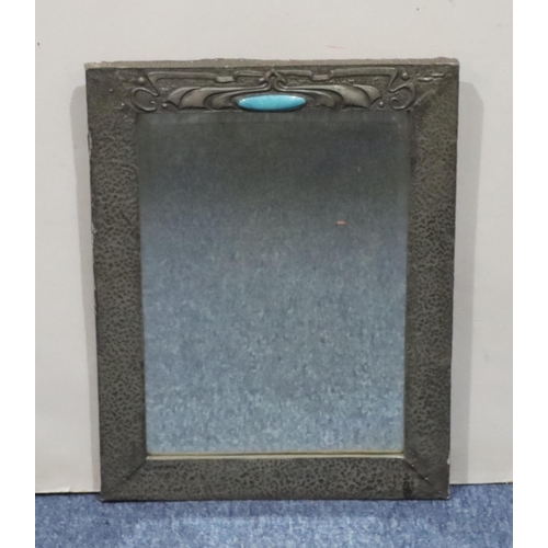 618 - An Arts and Crafts style hammered pewter hanging bevelled wall mirror with embossed decoration, inse... 