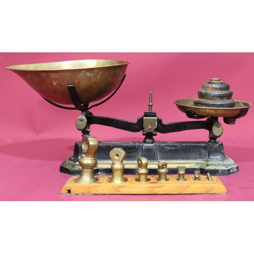 628 - A set of cast iron and brass scales with various graduated weights