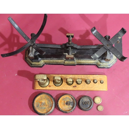 628 - A set of cast iron and brass scales with various graduated weights