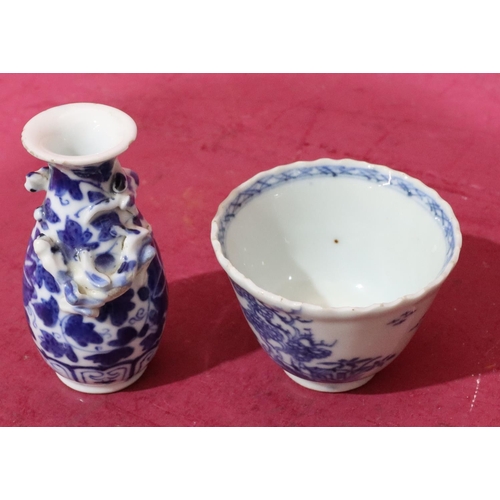 64 - An 18th/19th Century round trumpet shaped tea bowl on blue and white ground with tree and landscape ... 