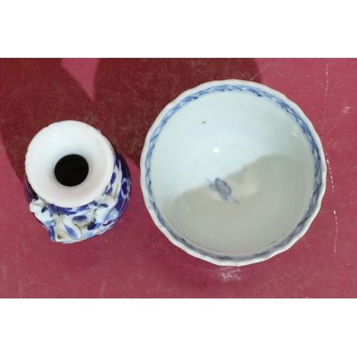 64 - An 18th/19th Century round trumpet shaped tea bowl on blue and white ground with tree and landscape ... 