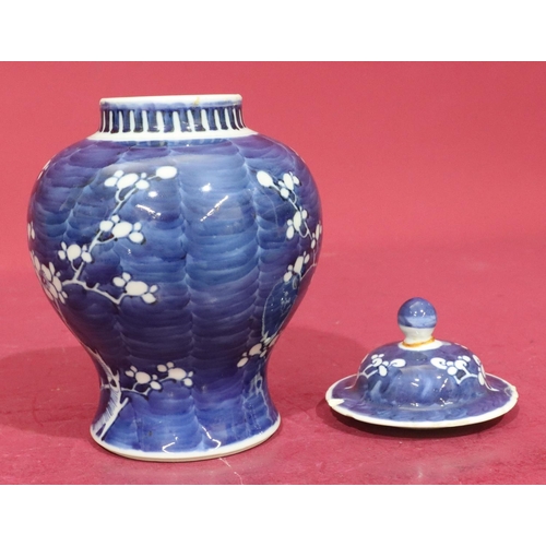 66 - A Chinese 19th/20th Century round bulbous thin neck ginger jar with cover on blue and white ground w... 