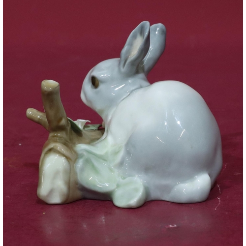 75 - A Lladro figure of a rabbit resting next to a log (encrusted flowers slight chips), 12cm wide