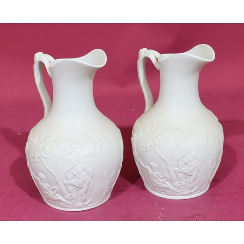 83 - A pair of 19th Century round bulbous thin neck jugs with mask head handles with allover raised class... 