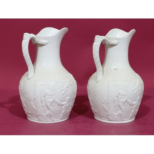 83 - A pair of 19th Century round bulbous thin neck jugs with mask head handles with allover raised class... 