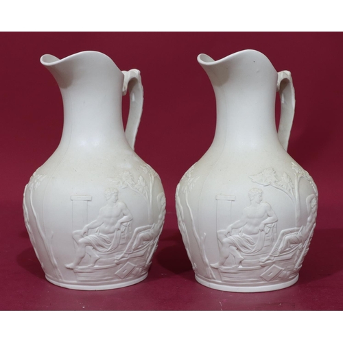 83 - A pair of 19th Century round bulbous thin neck jugs with mask head handles with allover raised class... 