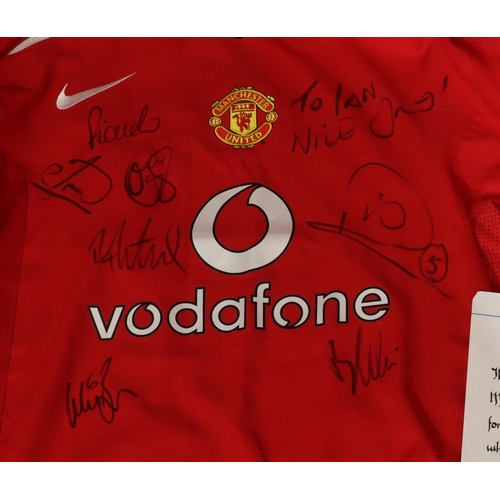 831 - A signed Manchester United signed football, donated by Bobby Charlton Teamwear 1994, with stand and ... 