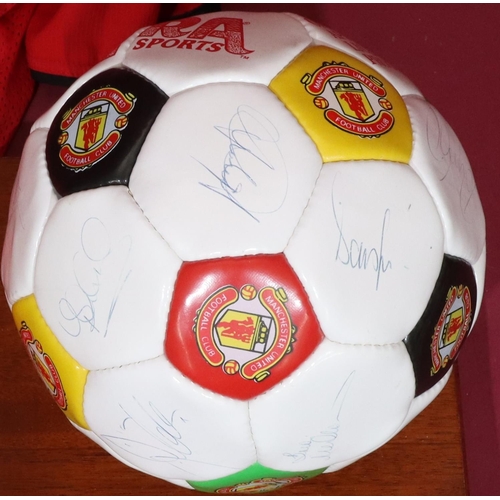 831 - A signed Manchester United signed football, donated by Bobby Charlton Teamwear 1994, with stand and ... 