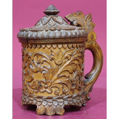 837 - A Continental carved treen beer stein with hinged lid with allover raised floral and leaf decoration... 