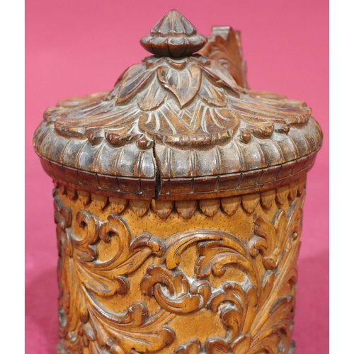 837 - A Continental carved treen beer stein with hinged lid with allover raised floral and leaf decoration... 