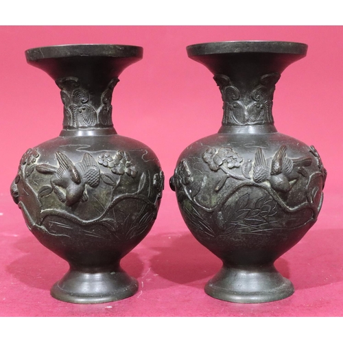 842 - A pair of Oriental bronze round bulbous thin neck trumpet shaped vases with raised bird, branch and ... 