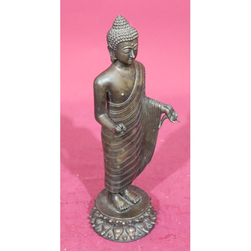 843 - A bronze figure of a standing Buddha on round base, 37.5cm high