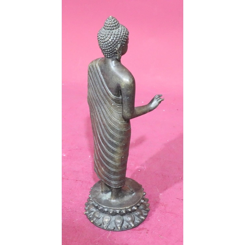 843 - A bronze figure of a standing Buddha on round base, 37.5cm high