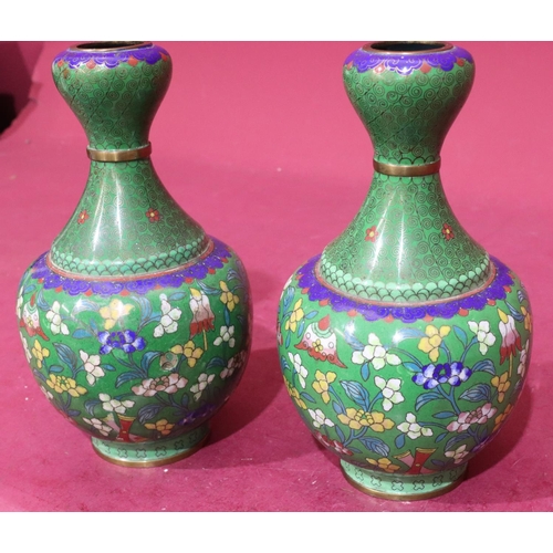 848 - A pair of Oriental cloisonné round bulbous thin necked vases on green ground with multicoloured flor... 