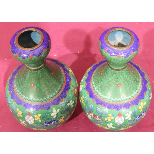 848 - A pair of Oriental cloisonné round bulbous thin necked vases on green ground with multicoloured flor... 