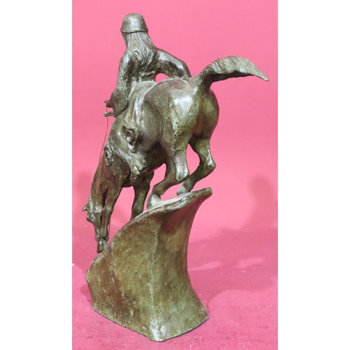 852 - A Remington style bronze figure of a Red Indian on horseback riding down slope, 46cm high