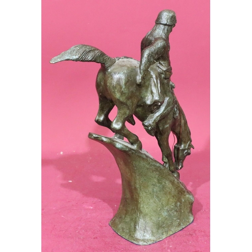 852 - A Remington style bronze figure of a Red Indian on horseback riding down slope, 46cm high