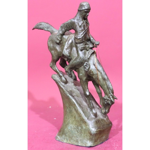 852 - A Remington style bronze figure of a Red Indian on horseback riding down slope, 46cm high