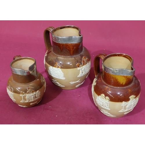 87 - A set of 3 Royal Doulton round bulbous thin neck jugs with London silver necks on brown ground with ... 