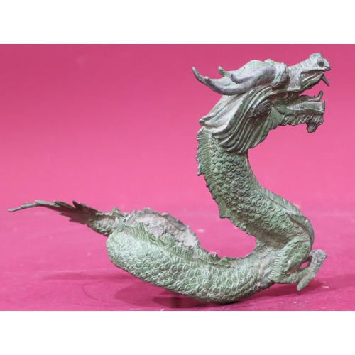 872 - A green bronze figure of a dragon, 24.5cm wide, 16cm high