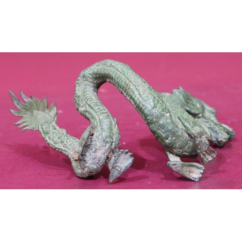 872 - A green bronze figure of a dragon, 24.5cm wide, 16cm high