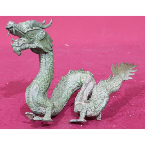 872 - A green bronze figure of a dragon, 24.5cm wide, 16cm high