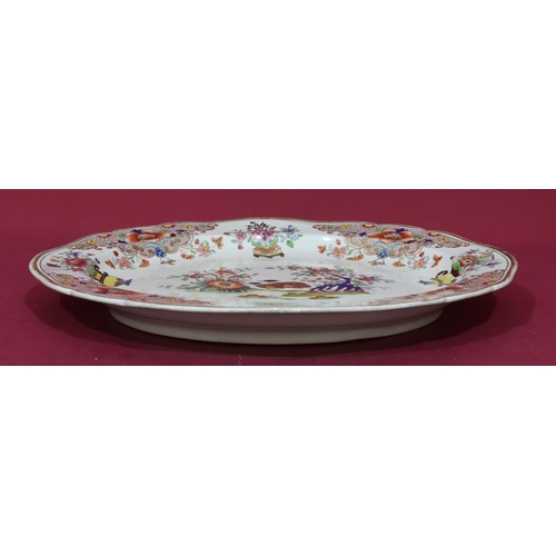 88 - A 19th Century oval scallop shaped meat plate on white ground with multicoloured bird, vase, floral,... 